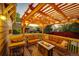 Outdoor back deck with a fire pit, comfortable seating, and string lights for cozy evenings at 4307 Lily Gulch Trl, Castle Rock, CO 80109
