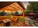 Cozy back deck with an outdoor fire pit, seating, and overhead string lights for relaxing evenings at 4307 Lily Gulch Trl, Castle Rock, CO 80109