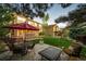 Spacious backyard with a stone patio, outdoor seating, and a lush lawn for recreation and relaxation at 4307 Lily Gulch Trl, Castle Rock, CO 80109