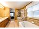 Bright bathroom with double vanity, soaking tub, glass shower, and tile flooring at 4307 Lily Gulch Trl, Castle Rock, CO 80109