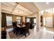 Elegant dining room with coffered ceilings, modern chandelier, and dark wood table set at 4307 Lily Gulch Trl, Castle Rock, CO 80109