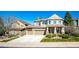 Charming two-story house featuring stone details, a long driveway, and lovely landscaping at 4307 Lily Gulch Trl, Castle Rock, CO 80109