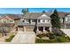 Beautiful two-story home featuring a stone facade, large driveway, and well-maintained landscaping at 4307 Lily Gulch Trl, Castle Rock, CO 80109