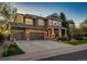 Inviting two-story home with a stone facade, covered front porch, and beautifully landscaped yard at 4307 Lily Gulch Trl, Castle Rock, CO 80109