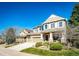 Attractive two-story house with stone accents, a spacious driveway, and manicured green lawn at 4307 Lily Gulch Trl, Castle Rock, CO 80109