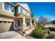 Charming covered front porch with stone columns, a bench, and manicured landscaping at 4307 Lily Gulch Trl, Castle Rock, CO 80109