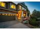 Inviting covered porch with stone columns, outdoor seating, and beautiful stone detailing at 4307 Lily Gulch Trl, Castle Rock, CO 80109