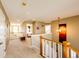 Upstairs hallway featuring carpeted floors, wooden railings, and natural light at 4307 Lily Gulch Trl, Castle Rock, CO 80109