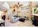 Open living area with a grand staircase, fireplace, and comfortable seating arrangement at 4307 Lily Gulch Trl, Castle Rock, CO 80109