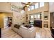 Bright living room with high ceilings, large windows, and comfortable seating around a fireplace at 4307 Lily Gulch Trl, Castle Rock, CO 80109