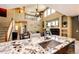 Open-concept kitchen and living area with high ceilings and a cozy fireplace at 4307 Lily Gulch Trl, Castle Rock, CO 80109