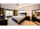 Spacious main bedroom featuring natural light, vaulted ceilings, and neutral carpet at 4307 Lily Gulch Trl, Castle Rock, CO 80109