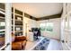 Cozy home office with built-in shelving, a comfortable chair, and a bright window at 4307 Lily Gulch Trl, Castle Rock, CO 80109
