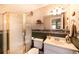 Bathroom with glass shower and tiled floors, a single-sink vanity, and a decorative wallpaper design at 3259 W 111Th Drive, Westminster, CO 80031