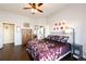 Bedroom features a comfortable bed, wood floors, and stylish decor at 3259 W 111Th Drive, Westminster, CO 80031