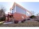 Exterior elevation of the home featuring gray siding, brick accents, and a red balcony, showcasing architectural details at 3259 W 111Th Drive, Westminster, CO 80031