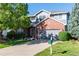 Charming two-story home boasts a gray garage door and a well-manicured front lawn with mature trees at 3259 W 111Th Drive, Westminster, CO 80031
