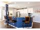 Open kitchen boasts seating at the peninsula, white cabinets, and stainless steel appliances at 3259 W 111Th Drive, Westminster, CO 80031