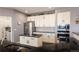 Well-equipped kitchen with stainless steel appliances, granite countertops, and sleek white cabinets at 3259 W 111Th Drive, Westminster, CO 80031