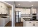 Modern kitchen features stainless steel appliances, white cabinetry, and a stylish backsplash at 3259 W 111Th Drive, Westminster, CO 80031