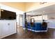 Spacious living area flows into kitchen with barstool seating and a big screen TV at 3259 W 111Th Drive, Westminster, CO 80031