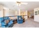 Living room featuring two blue armchairs, a ceiling fan, neutral walls, and carpet flooring at 3259 W 111Th Drive, Westminster, CO 80031