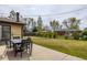 Backyard featuring large lawn, patio with seating, and mature trees at 5070 W 66Th Ave, Arvada, CO 80003