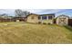 Backyard featuring large lawn, patio with seating, shed, and wooden fence at 5070 W 66Th Ave, Arvada, CO 80003