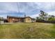 Backyard featuring large lawn, patio with seating, shed, and wooden fence at 5070 W 66Th Ave, Arvada, CO 80003