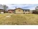 Backyard featuring large lawn, patio with seating, shed, and wooden fence at 5070 W 66Th Ave, Arvada, CO 80003