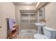 Bathroom with walk-in shower, pedestal sink, tile walls and flooring at 5070 W 66Th Ave, Arvada, CO 80003