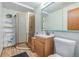 Bathroom featuring glass shower stall and wood vanity with framed mirror at 5070 W 66Th Ave, Arvada, CO 80003