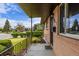 Charming front porch with iron railings and brick exterior, offering curb appeal at 5070 W 66Th Ave, Arvada, CO 80003