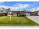 Brick home with well-maintained lawn, mature shrubs, and a paved driveway at 5070 W 66Th Ave, Arvada, CO 80003
