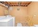 Unfinished laundry room with washer, dryer, bare ceiling, and hanging rack at 5070 W 66Th Ave, Arvada, CO 80003