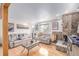 Spacious living area featuring a stone fireplace and hardwood floors at 5070 W 66Th Ave, Arvada, CO 80003