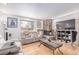 Comfortable living room with a stone fireplace, hardwood floors, and modern furnishings at 5070 W 66Th Ave, Arvada, CO 80003