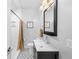 Clean bathroom with a modern vanity and geometric tile floor at 2257 S High St, Denver, CO 80210