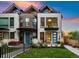 Contemporary two-story home with brick and white walls, a green lawn, and blue doors at 2257 S High St, Denver, CO 80210