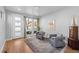 Bright living room with hardwood floors and access to a patio at 2257 S High St, Denver, CO 80210