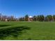 Large grassy park with a brick building and trees at 2257 S High St, Denver, CO 80210