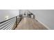 Upper hallway with a modern railing and wood floors at 2257 S High St, Denver, CO 80210