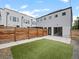Backyard featuring artificial turf and wooden privacy fence, with patio area at 3715 Kalamath St, Denver, CO 80211
