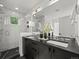 Double vanity bathroom featuring modern fixtures, a glass-enclosed shower, and elegant design at 3715 Kalamath St, Denver, CO 80211