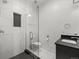 Modern bathroom featuring a glass shower, black vanity and white subway tiling at 3715 Kalamath St, Denver, CO 80211