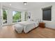 A light-filled bedroom offers a calm, inviting atmosphere with large windows and hardwood floors at 3715 Kalamath St, Denver, CO 80211