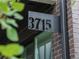 A modern house number sign in dark metal on a brick and siding exterior at 3715 Kalamath St, Denver, CO 80211