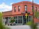 Pinwheel Coffee shop exterior featuring a red brick facade, large windows, and sidewalk seating at 3715 Kalamath St, Denver, CO 80211