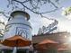 Exterior view of Little Personal Ice Cream building featuring giant milk can, outdoor umbrellas, and rooftop patio at 3715 Kalamath St, Denver, CO 80211
