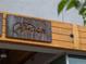 Close up of the metal 'Wither Flower' sign, mounted on wood, at the entrance of the building at 3715 Kalamath St, Denver, CO 80211